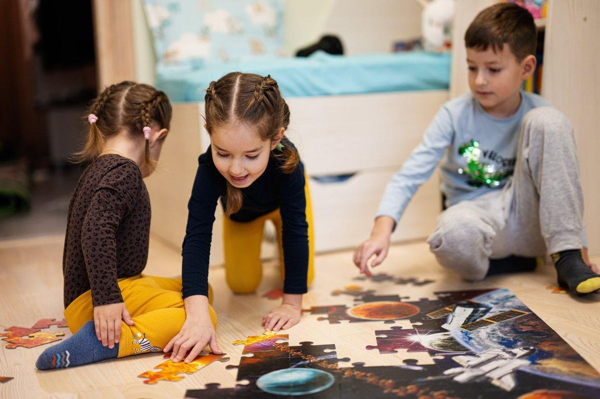 Des enfants jouant à un escape game familial DIY à la maison, ambiance tamisée et décoration créative.