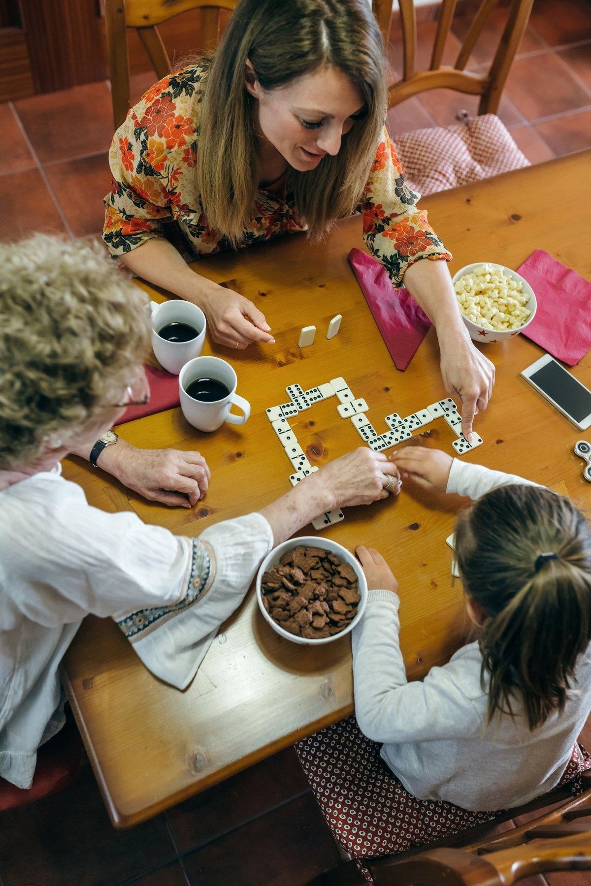 Une soirée conviviale en famille autour d’un jeu de société, renforçant la convivialité intergénérationnelle.