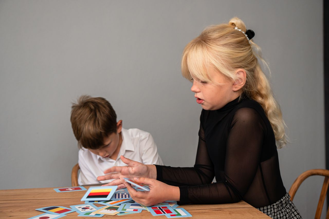 Jeunes ados autour d’une table de jeu de rôle, cartes en main et ambiance chaleureuse.
